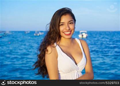 Mexican latin woman smiling at Caribbean sea of Riviera Maya in Mexico