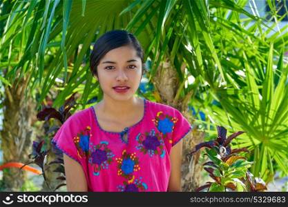 Mexican latin woman with mayan dress in the jungle