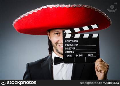 Mexican man with movie board clapboard