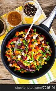 Mexican mixture of vegetables, cooked in a frying pan. Studio Photo. Mexican mixture of vegetables, cooked in a frying pan