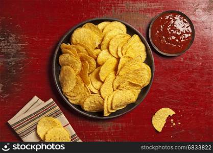 Mexican nachos chips with salsa sauce on rustic background. Mexican food concept