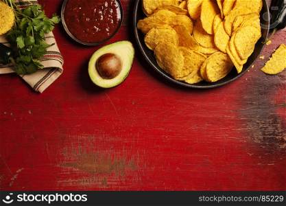 Mexican nachos chips with salsa sauce on rustic background. Mexican food concept