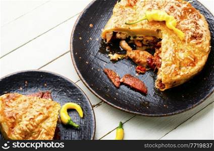 Mexican pie with smoked sausage and chicken. Meat pie.. Sausage and chicken pie