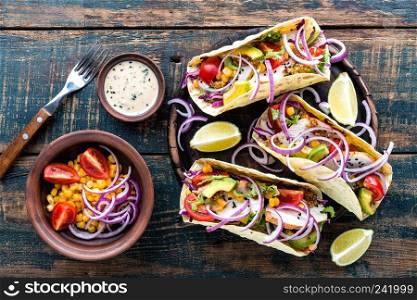 Mexican tacos with chicken meat, vegetables and fresh greens