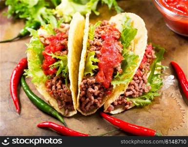 mexican tacos with meat and salsa on a board