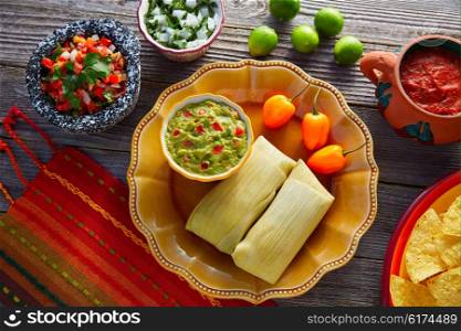 Mexican Tamale tamales of corn leaves with chili and sauces