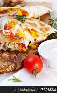Mexican tortilla with meat stuffing, corn and vegetable salsa
