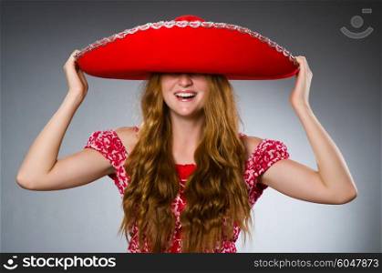 Mexican woman wearing red sombrero