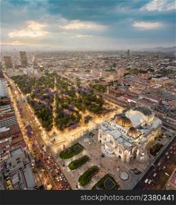Mexico city aerial view from Torre Latinoamericana. Palacio de Bellas Artes, Alameda Central and downtown in lights at sunset.