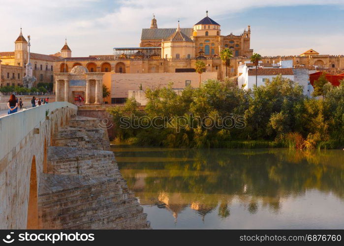 Mezquita and Roman bridge in Cordoba, Spain. Great Mosque Mezquita - Catedral de Cordoba and Roman bridge across Guadalquivir river in the morning, Cordoba, Andalusia, Spain