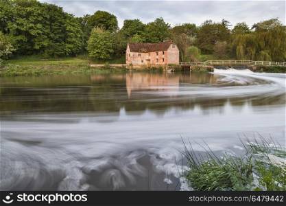 MGB1781604. UK. Early morning view across River Stour to Sturminster Newton Mill in Dorset.