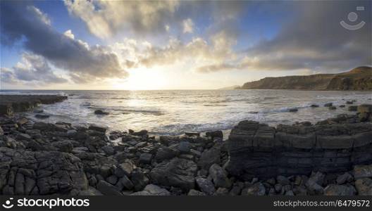 MGB501415. Seascapes. Brandy Bay colorful sunrise panorama landscape in Dorset at low tide