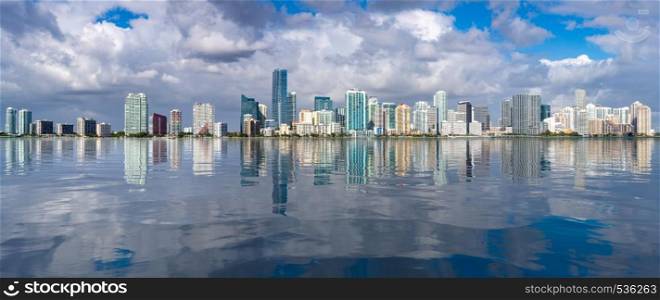 Miami cityscape skyline from Rickenbacker causeway looking like sea level has risen. View of Miami Skyline with artificial reflection
