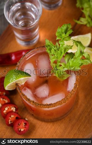 Michelada the Mexican Bloody Mary. Made with tequila, spicy sauce, served over ice in a glass of celery with a peppery rim, garnished with a stalk of celery and a wedge of lime. Drinks and cocktails with hot sauce, add some spice to your life