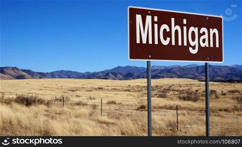 Michigan road sign with blue sky and wilderness
