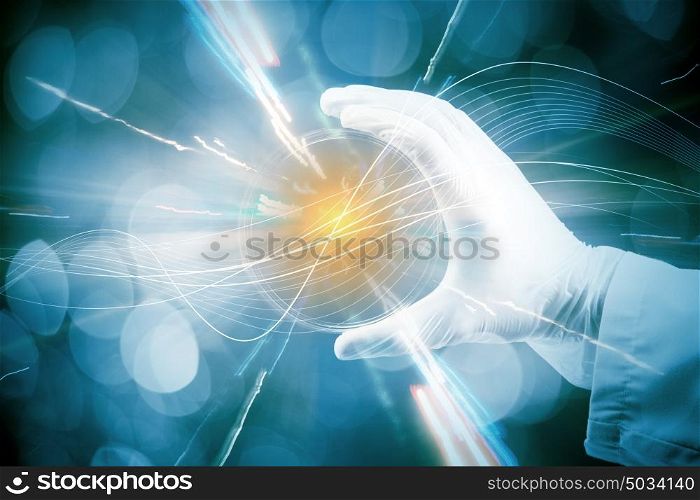 Microbiology concept. Close up of scientist hand holding tube with leaf