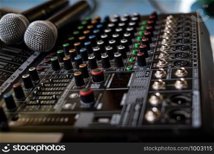 Microphone and audio sound mixer analog at the sound control room on blurred background