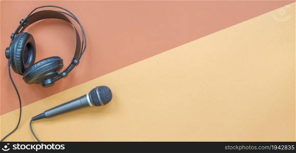 Microphone and headphone on a beige and brown background