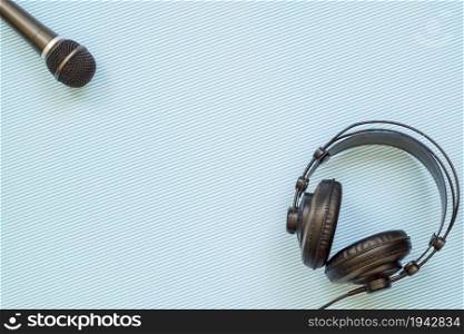 Microphone and headphone on a light blue background