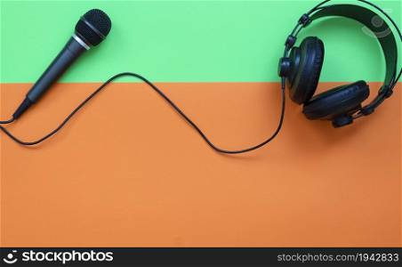 Microphone and headphone on a orange and green background