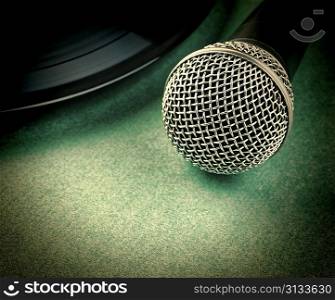 microphone and old vinyl record on a green background