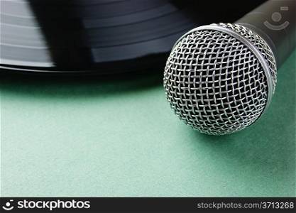 microphone and old vinyl record on a green background