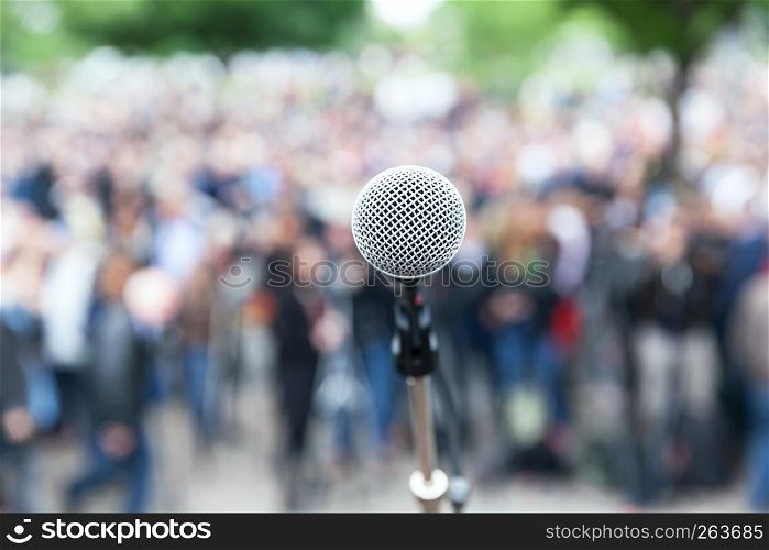 Microphone in focus against blurred crowd