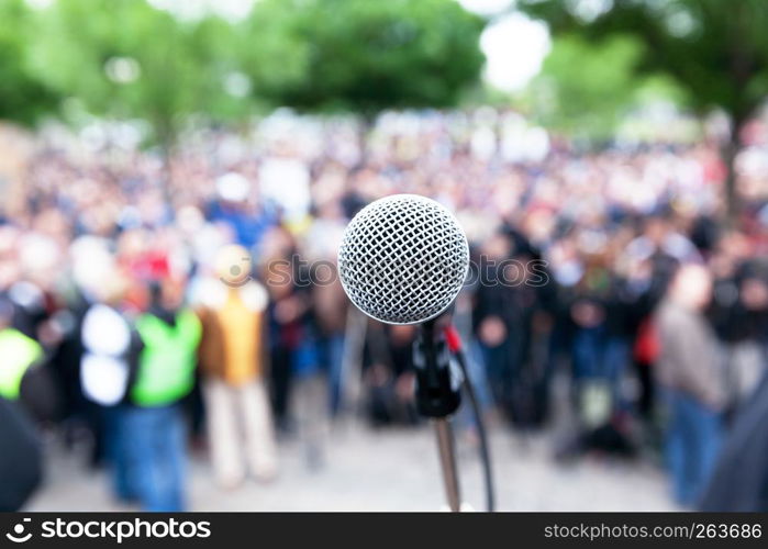 Microphone in focus against blurred crowd