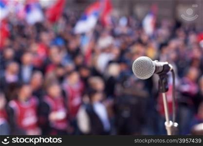 Microphone in focus against unrecognizable crowd