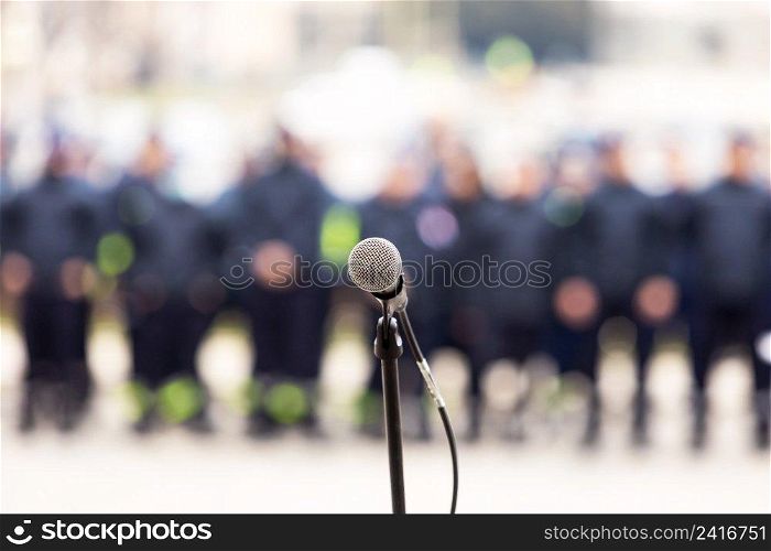 Microphone in focus, blurred people in the background