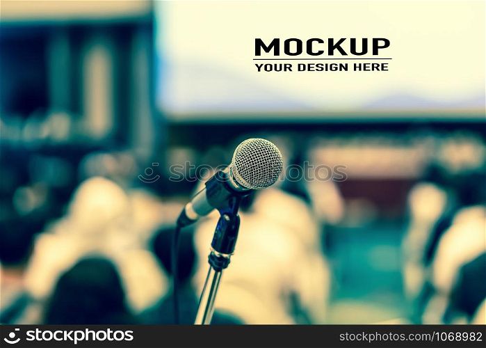 Microphone over Audience listening Speakers on the stage with presentation via projector in the conference hall or seminar meeting and workshop event, business and education about investment concept