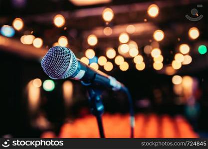 Microphone stand in an event hall, lights, no people