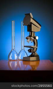 Microscope against blue gradient background