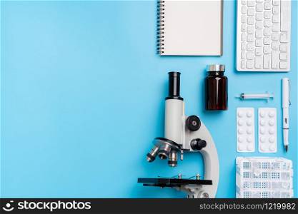 Microscope biology and chemistry subject on the desk from top view