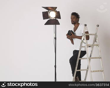 Mid adult (30-35 years) photographer in studio