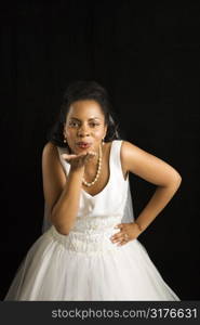 Mid-adult African-American bride blowing a kiss.