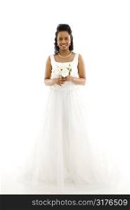 Mid-adult African-American bride holding bouquet on white background.