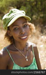 MId-adult African American female wearing cap and making eye contact.