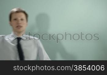 Mid adult businessman arriving late, smiling at camera with arms crossed