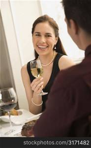 Mid adult Caucasian couple smiling and drinking wine and dining.