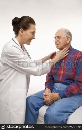 Mid-adult Caucasian female doctor checking an elderly Caucasian male&acute;s pulse.