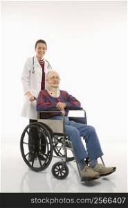 Mid-adult Caucasian female doctor pushing elderly Caucasian male with neck brace in wheelchair.