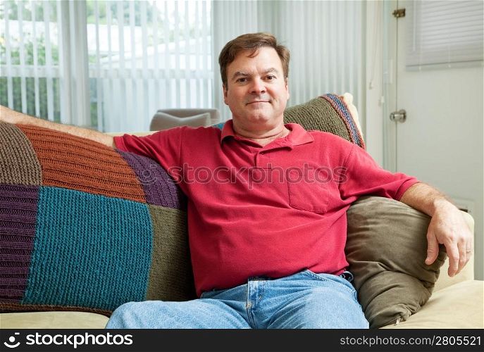 Mid adult caucasian man relaxing at home on the couch.