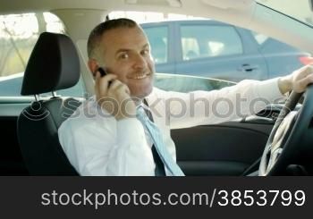 Mid adult caucasian manager talking on the phone and looking at camera. Dolly shot