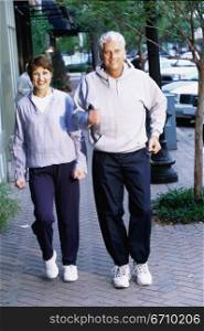 Mid adult couple jogging together