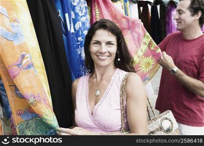 Mid adult couple looking clothes at a market stall