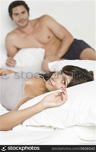 Mid adult couple lying in bed