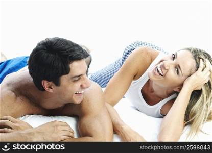 Mid adult couple lying on the bed and smiling