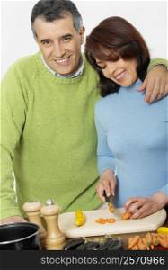 Mid adult couple making salad