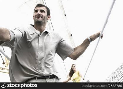 Mid adult couple on a sailing ship and smiling